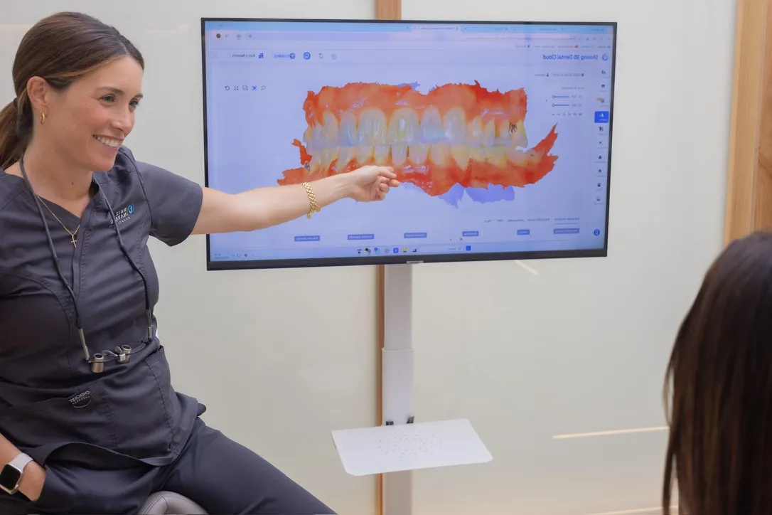 Doctora mostrando un escaneo intraoral 3D a una paciente